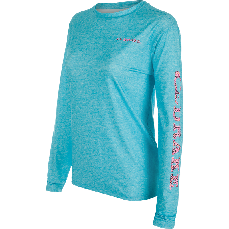 Women's Performance Crew Heather Shirt, a lightweight blue long sleeved top with leopard print sleeves. Features include Built-In Cooling, UPF 50, Moisture Wicking, Breathable Stretch, and Quick Drying. Perfect for outdoor activities.