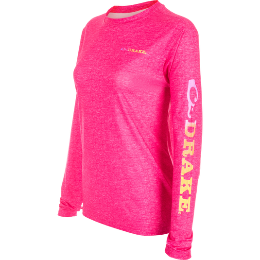 Women's Performance Crew Heather Shirt, a lightweight pink long sleeved top with yellow writing and a pink ribbon detail. Perfect for outdoor activities with cooling, UPF 50 sun protection, moisture-wicking, and quick-drying features.