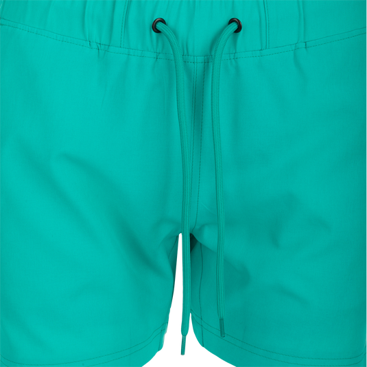 Women's Commando Lined Short 4.5": Close-up of versatile green shorts with zipper and scalloped hem, ideal for gym or beach. Features 4-way stretch, quick-drying fabric, moisture-wicking liner, elastic waistband with drawstring, and multiple pockets.