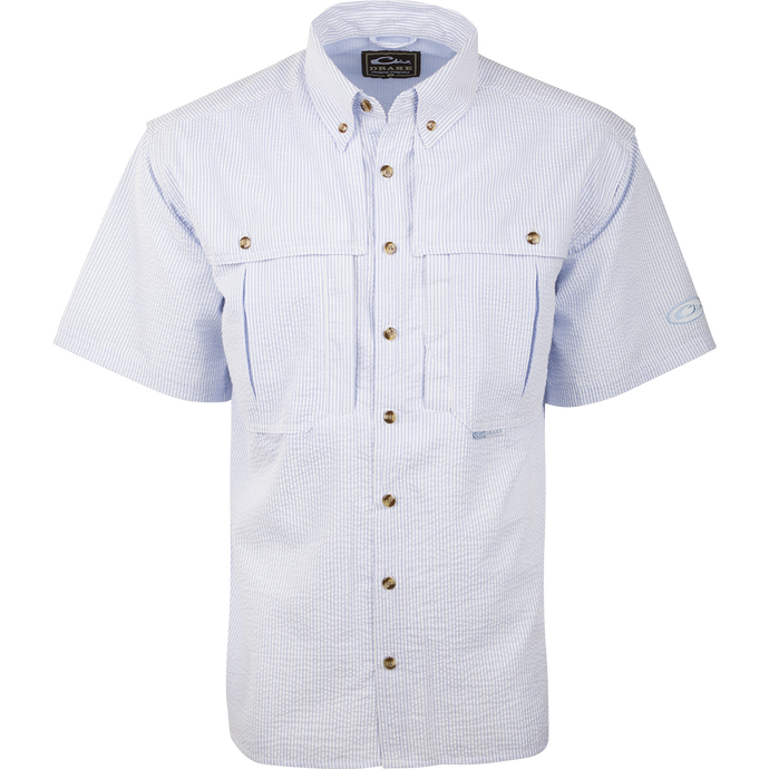 A Seersucker Wingshooter's Shirt with a button-down collar, front and back heat vents, and multiple pockets. Made of StayCool™ fabric for breathability and comfort. Perfect for spring and summer outings.