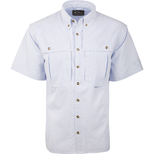 A Seersucker Wingshooter's Shirt with a button-down collar, front and back heat vents, and multiple pockets. Made of StayCool™ fabric for breathability and comfort. Perfect for spring and summer outings.