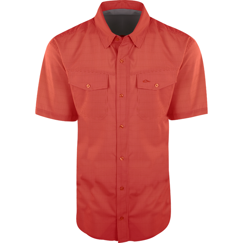 A red checkered Traveler Minicheck Short Sleeve shirt with buttons, made of lightweight, breathable poly/spandex fabric for ultimate comfort and freedom of movement. Ideal for the man on the go, whether on vacation or running errands. Wrinkle-resistant and quick-drying.