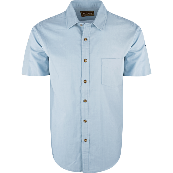 A light blue NeverTuck Shirt S/S with an open collar style and left chest pocket, made of soft-washed 100% cotton for comfort and breathability. Perfect for pairing with your favorite Drake outerwear.