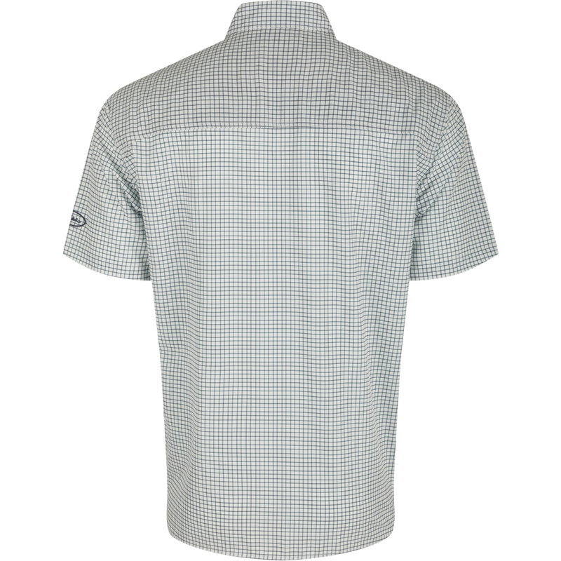 A back view of the Traveler's Minigrid Short Sleeve Shirt, a lightweight and breathable shirt with four-way stretch for freedom of movement. Ideal for the man on the go, whether on vacation or running errands. Split tail hem allows for tucked or untucked wear.