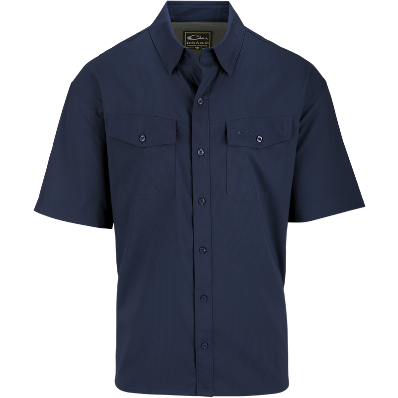 A blue short sleeved shirt with hidden button-down collar, chest pockets, and split tail hem. Made of 100% Polyester dobby fabric with UPF30 sun protection. Versatile for any season.