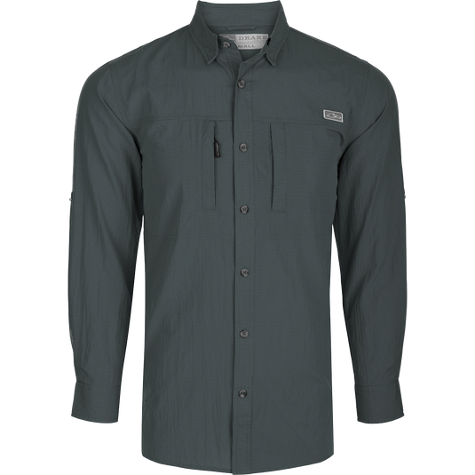 Classic Seersucker Minicheck Shirt L/S: A black long-sleeved shirt with buttons, featuring a hidden zippered chest pocket and a magnet closure on the other pocket. Made from a soft and featherweight performance fabric with UPF30 sun protection. Vented cape back and split tail hem for added ventilation and versatility. Perfect for hunting, fishing, and outdoor activities.