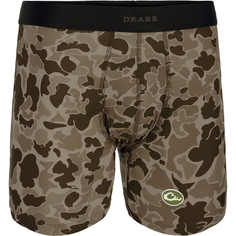 A close-up of the Commando Boxer Brief, featuring a camouflage pattern and a green and white logo. Comfortable, moisture-wicking fabric with four-way stretch for freedom of movement. Elastic waistband and functional fly. Perfect for hunting and outdoor activities.