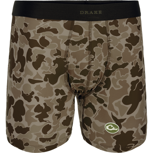 A close-up of the Commando Boxer Brief, featuring a camouflage pattern and a green and white logo. Comfortable, moisture-wicking fabric with four-way stretch for freedom of movement. Elastic waistband and functional fly. Perfect for hunting and outdoor activities.