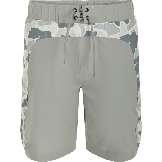 Commando Lined Board Short 9": A versatile grey shorts with camouflage pattern, 4-way stretch, quick-drying fabric, and built-in liner. Features cargo pockets, elastic waistband, and adjustable drawstring. Ideal for beach to bar transitions.