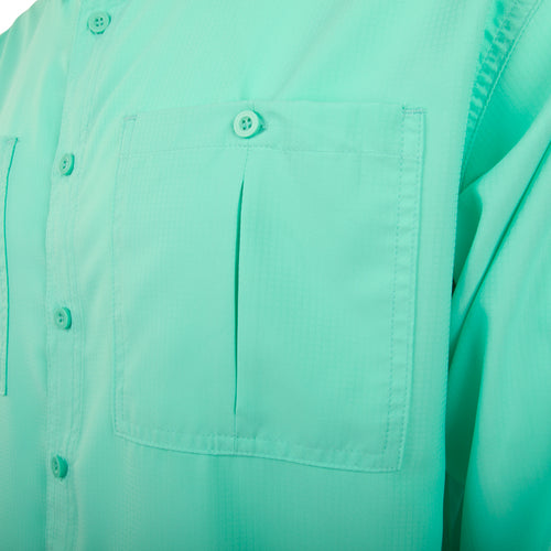 A close-up of the Flyweight Shirt with Vented Back L/S. Features include vented mesh back, vertical chest pockets, and hidden button downs.
