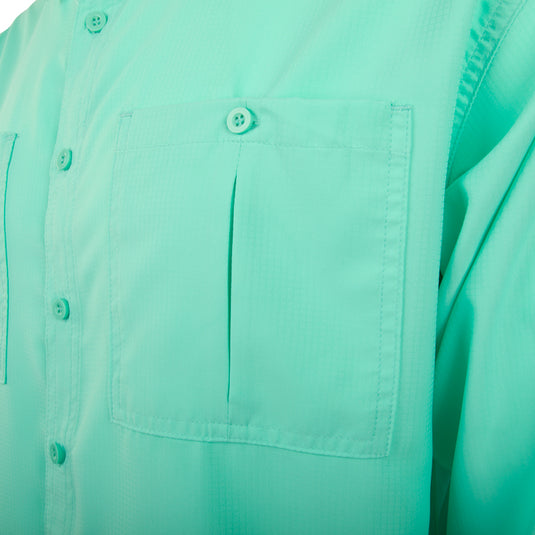 A close-up of the Flyweight Shirt with Vented Back L/S. Features include vented mesh back, vertical chest pockets, and hidden button downs.
