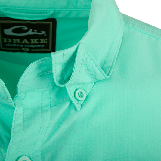 A close-up of the Flyweight Shirt with Vented Back L/S. Lightweight and breathable, this 100% polyester shirt is perfect for warm-weather outdoor activities. Features include Sol-Shield™ UPF 50+ sun protection, vented mesh back, and horizontal chest pockets. Quick-drying and moisture-wicking.