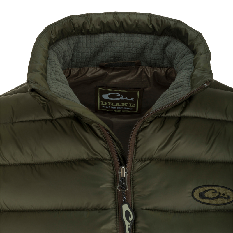 A close-up of the Solid Double-Down Jacket with zipper and label details. Stay warm and stylish in this midweight jacket with synthetic down insulation and YKK zippered pockets. Perfect for outdoor adventures!