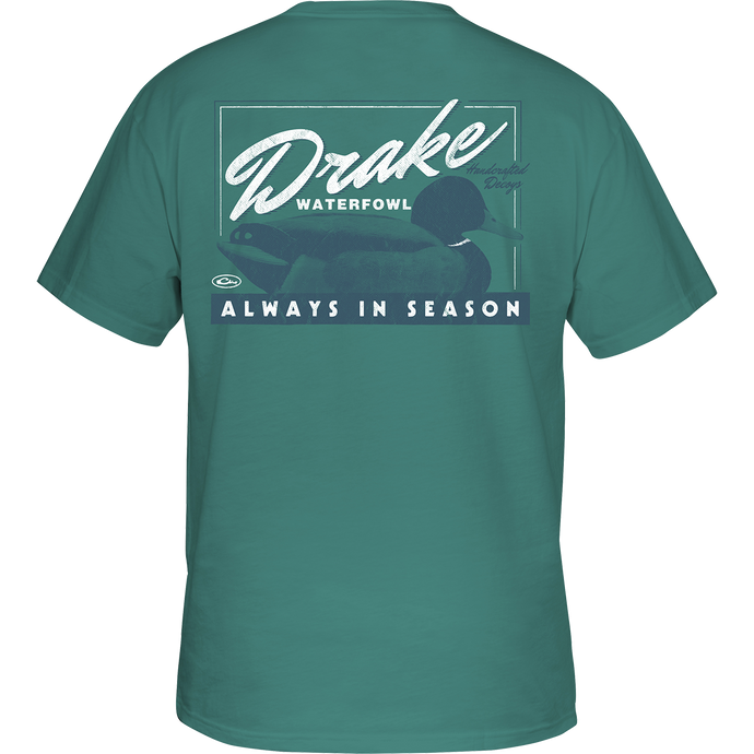 Alt text: Handcrafted Decoy T-Shirt by Drake Waterfowl, featuring a duck graphic on a green shirt. Drake logo on front pocket. Made of soft fabric blend, lightweight at 180 GSM. Final Sale.