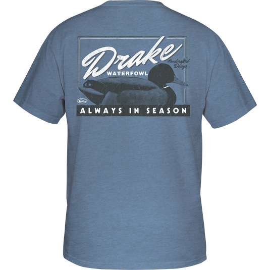 Alt text: Handcrafted Decoy T-Shirt featuring a duck graphic on a blue shirt, with a Drake logo on the front pocket. Made from a soft fabric blend for comfort, ideal for hunting and casual wear.