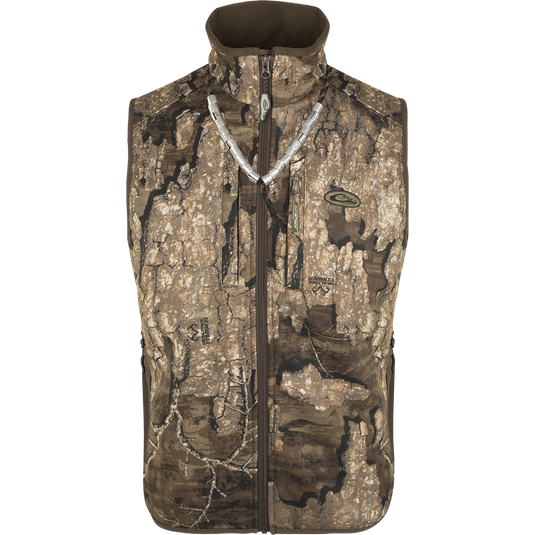 A close-up of the EST Camo Windproof Tech Vest, featuring a tree pattern and a zipper. This vest stops biting winds, providing comfort and warmth during hunting.