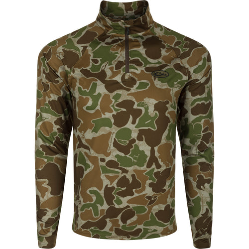 A close-up of the EST Microlite 1/4 Zip Pullover, a camouflage shirt with a zipper. Designed for performance with 4-way stretch, raglan sleeves, and integrated thumb loops. Offers superior protection with Shield 4 Sun™ UPF 50+, Shield 4 Coolant™, Shield 4 Odor™, and Shield 4 Stains™ treatments.