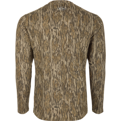 A Youth EST Camo Performance Long Sleeve Crew shirt with a tree pattern, offering comfort and protection for outdoor activities. Made of 92% Polyester/8% Spandex with 4-Way Stretch and Shield 4 treatments.