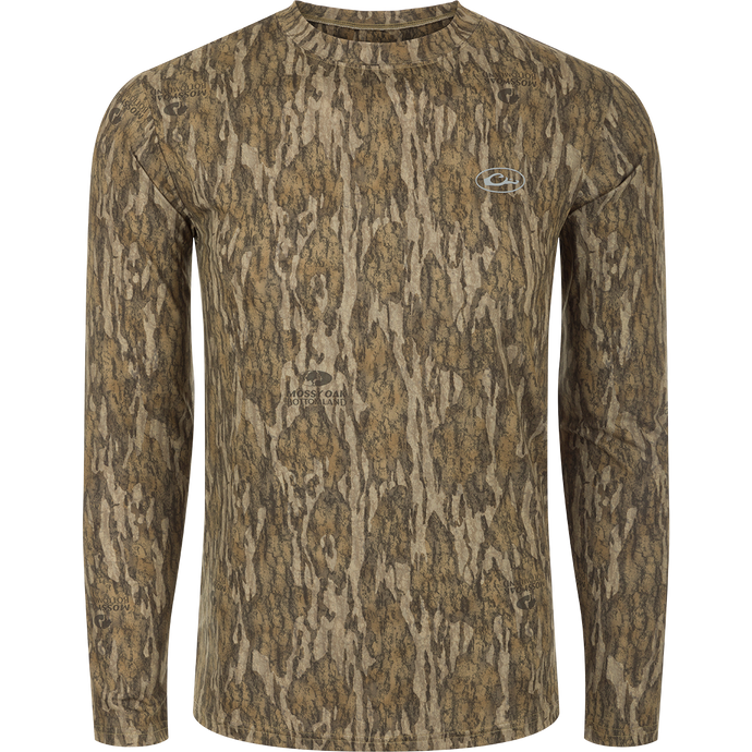 A Youth EST Camo Performance Long Sleeve Crew shirt with a tree pattern, offering comfort and protection with 4-Way Stretch and Shield 4 treatments.
