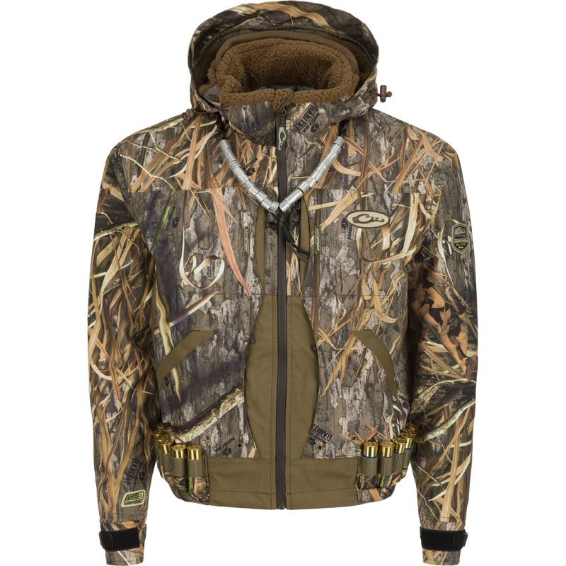 Guardian Elite™ Flooded Timber Jacket - Shell Weight: Camouflage jacket designed for tree hunters, with lower cut and drain holes in pockets for wading. Waterproof, windproof, and breathable. Features multiple pockets, adjustable hood, and reinforced fabric.