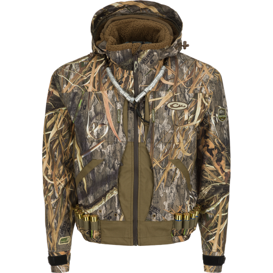 Guardian Elite™ Flooded Timber Jacket - Shell Weight: Camouflage jacket designed for tree hunters, with lower cut and drain holes in pockets for wading. Waterproof, windproof, and breathable. Features multiple pockets, adjustable hood, and reinforced fabric.