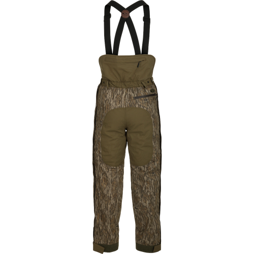 A pair of insulated hunt pants with suspenders, designed to retain body heat below the waist. Features a rear flap for kidney warmth.