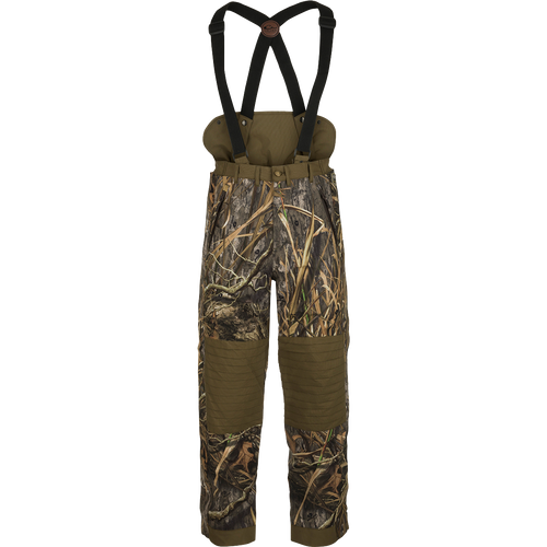 LST Guardian Elite High-Back Insulated Hunt Pant: Camouflage overalls with straps, designed to retain body heat below the waist. Waterproof, windproof, and breathable fabric with reinforced knees and seat. Removable suspenders and easy on/off side leg zippers.