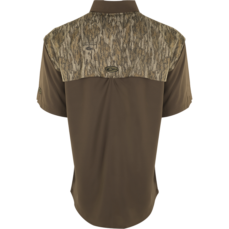 A lightweight, breathable hunting shirt with a camouflage design. Made of 100% polyester Flyweight fabric for quick drying and moisture-wicking. Features UPF 50+ sun protection, back heat vents, mesh side panels, Magnattach™ chest pocket, and zippered chest pocket. Perfect for early season hunting.