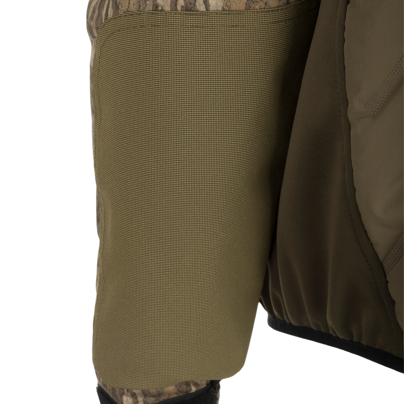 A close-up of the Youth LST Guardian Flex Double Down Eqwader 1/4 Zip Jacket, showcasing the waterproof/windproof upper body and arms, double down insulation, and HD3 elbow/forearm protection. Ideal for outdoor pursuits with improved fit, no-water cuff closures, and abrasion-resistant lower body. Extra storage provided by two Magnattach and two zippered vertical chest pockets.
