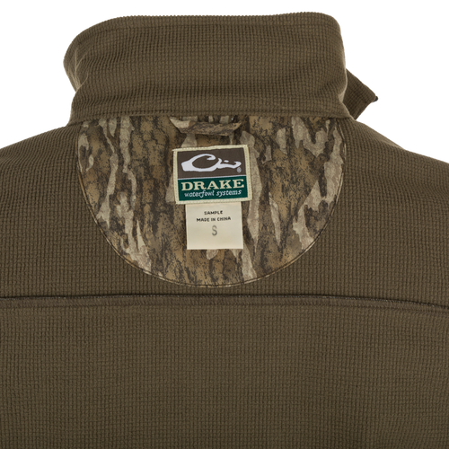 MST Windproof Softshell Vest - A close-up of the jacket with a label and logo. Expert-level functionality with secure storage pockets and customizable fit. Superior comfort and breathability with 4-Way Stretch and Grid-Fleece Collar Lining.