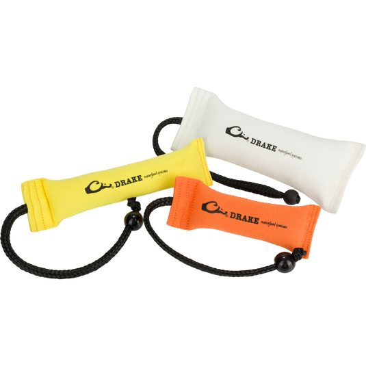 White, yellow and orange Firehose Bumpers with molded ball and cork filling for durability and easy throwing. Perfect for visual and scent training.