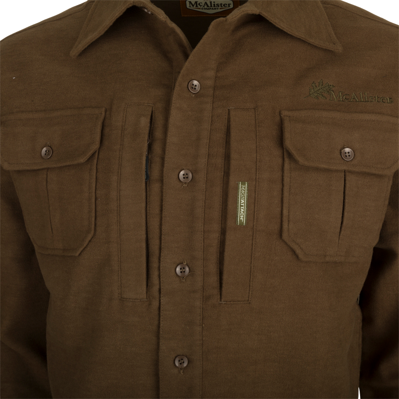 A brown jac-shirt with pockets, featuring windproof protection, 4-way stretch, and an oversized fit.