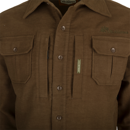 A brown jac-shirt with pockets, featuring windproof protection, 4-way stretch, and an oversized fit.