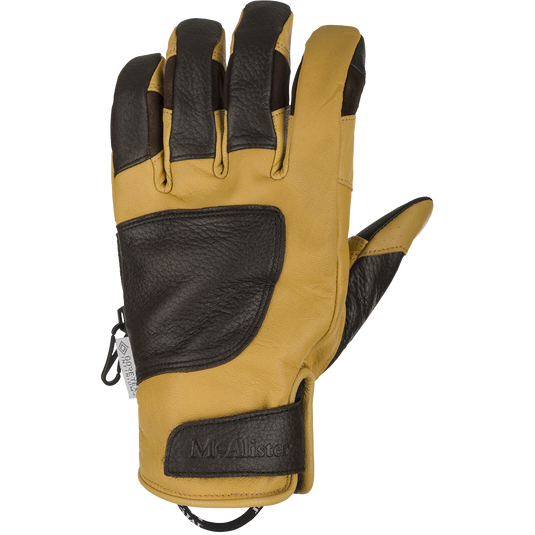 McAlister Upland Gloves With Windstopper: A close-up of a brown and black glove made of 100% goat leather. Features a polyester fleece lining and adjustable Velcro cuff closure for a secure fit.