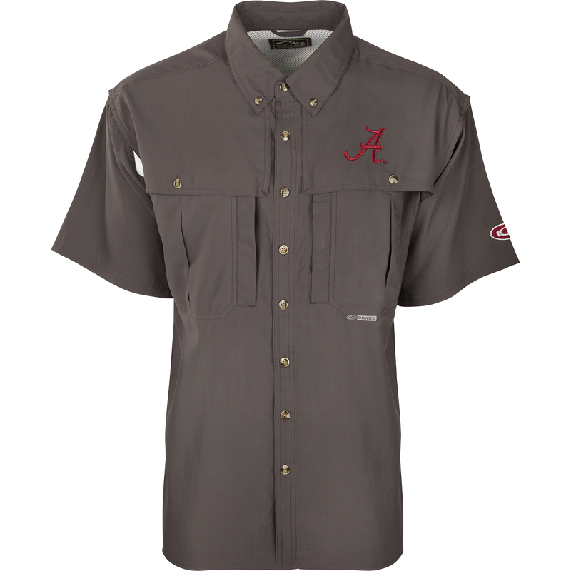 A close-up of the Alabama S/S Flyweight Wingshooter shirt, featuring a logo and red letter. Lightweight and breathable, with moisture-wicking fabric, vented back, and UPF 50+ sun protection. Magnattach™ and zippered pockets included.