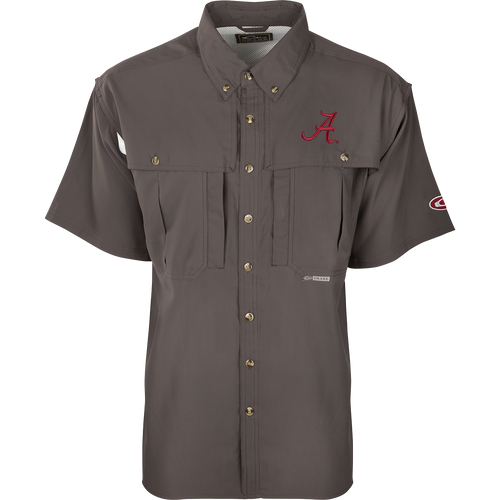 A close-up of the Alabama S/S Flyweight Wingshooter shirt, featuring a logo and red letter. Lightweight and breathable, with moisture-wicking fabric, vented back, and UPF 50+ sun protection. Magnattach™ and zippered pockets included.