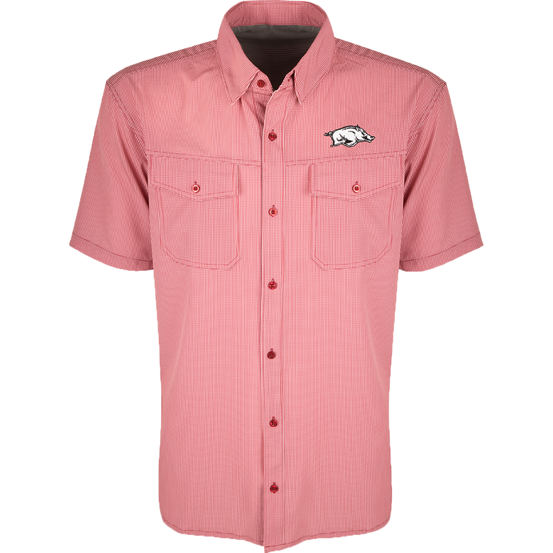 Arkansas S/S Traveler's Shirt, a red and white checkered shirt with a pig on it. Lightweight, breathable fabric with four-way stretch for comfort. Moisture-wicking, wrinkle-resistant construction. Features 2 chest pockets with button flaps. Ideal for early season baseball games or weekend tailgates.