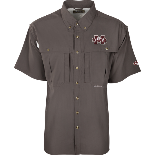 A close-up of the Mississippi State S/S Flyweight Wingshooter shirt with a logo on it, featuring a vented back design, quick-drying fabric, and multiple pockets for outdoor activities.