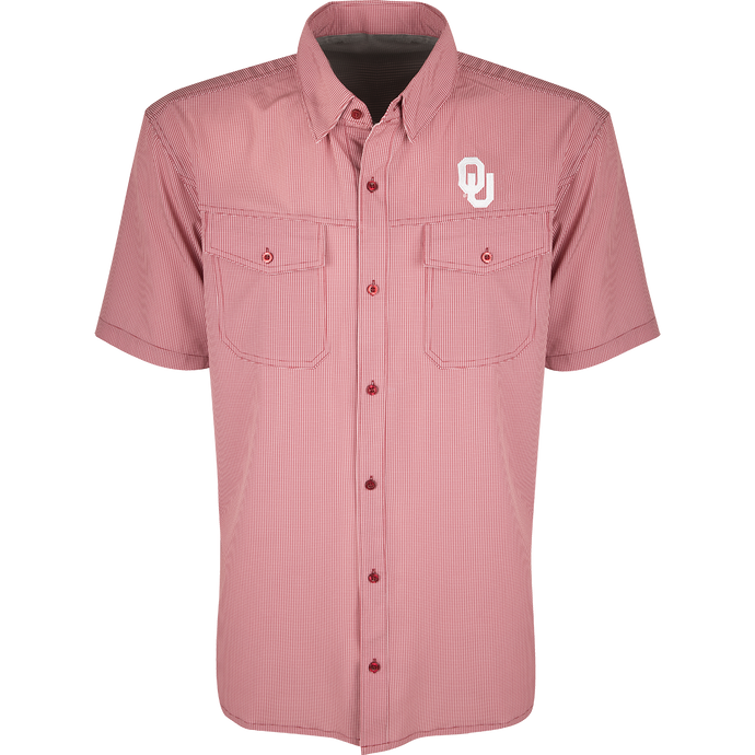 A red and white checkered shirt with collar and button flaps. Made of lightweight, breathable poly/spandex fabric with four-way stretch. Ideal for football games or weekend tailgates. Features moisture-wicking and wrinkle-resistant construction. Oklahoma logo embroidered on the left chest.