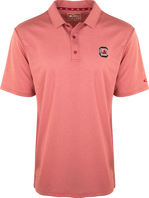 South Carolina Vintage Heather Polo: A red polo shirt with the official South Carolina logo on the left chest. Made of 100% polyester with a vintage heather finish. Features four-way stretch, quick-drying, moisture-wicking, and breathable fabric. Perfect for Gamecocks fans.