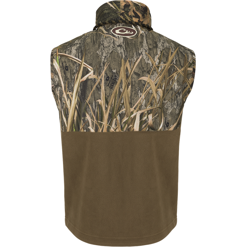 Back view of MST Eqwader Vest - Habitat featuring Mossy Oak camouflage and solid brown fleece, with logo at nape, highlighting outdoor functionality and storage pockets.