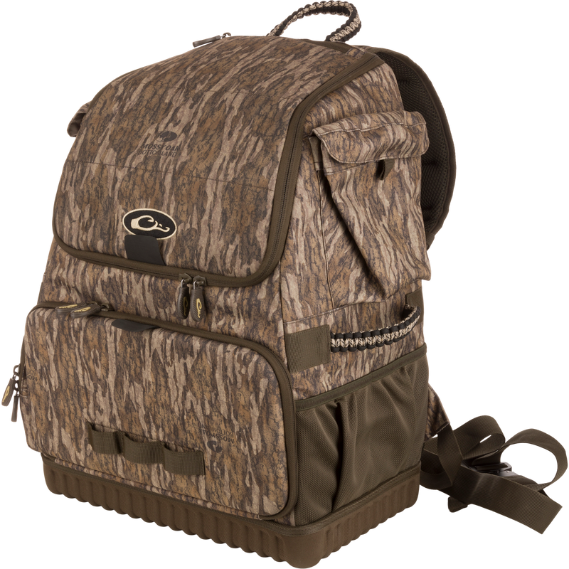 Tree Hugger Timber Pack with camo pattern, multiple zippered compartments, padded straps, molded hard bottom, paracord detailing; ideal for outdoor activities like hunting or fishing.