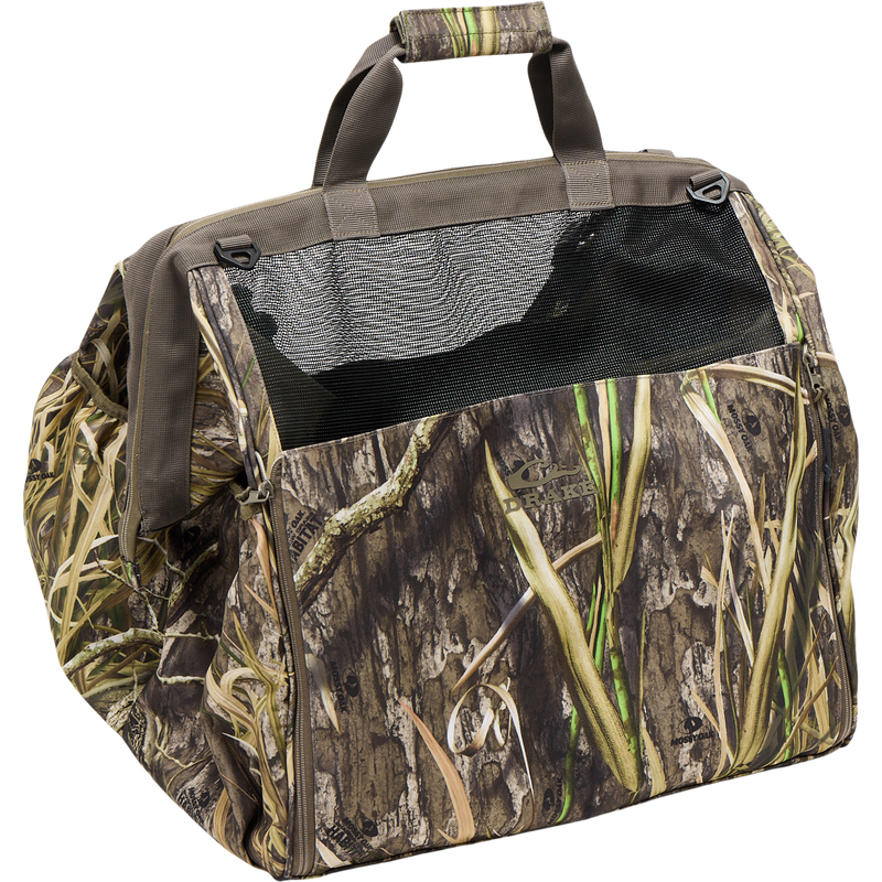 Guardian Elite Wader Bag by Drake, featuring camouflage pattern, zippered front, mesh window, padded handle, and versatile carrying options for organized hunting gear transport.