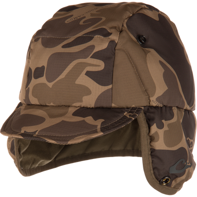 Close-up of the LST Down Hat, a padded camouflage-print winter cap with short brim and fold-down ear flaps, featuring durable, water-repellent ripstop fabric and premium insulation.