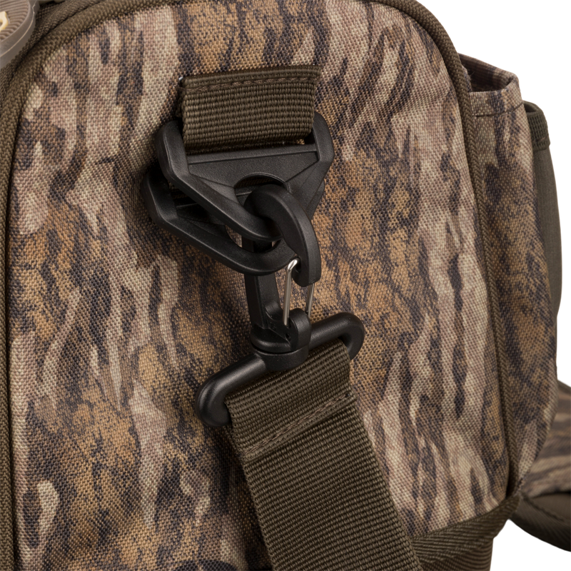 Tree Hugger Shoulder Bag with camo-pattern, featuring adjustable webbing strap, swivel hook, and durable foam hardshell for outdoor hunting gear from Drake Waterfowl.