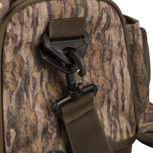 Tree Hugger Shoulder Bag with camo-pattern, featuring adjustable webbing strap, swivel hook, and durable foam hardshell for outdoor hunting gear from Drake Waterfowl.