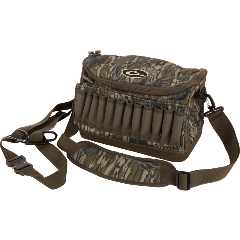 Tree Hugger Shoulder Bag with camo pattern, zip-top, adjustable strap, shell loops, and waterproof bottom, designed for hunting gear storage and outdoor durability.