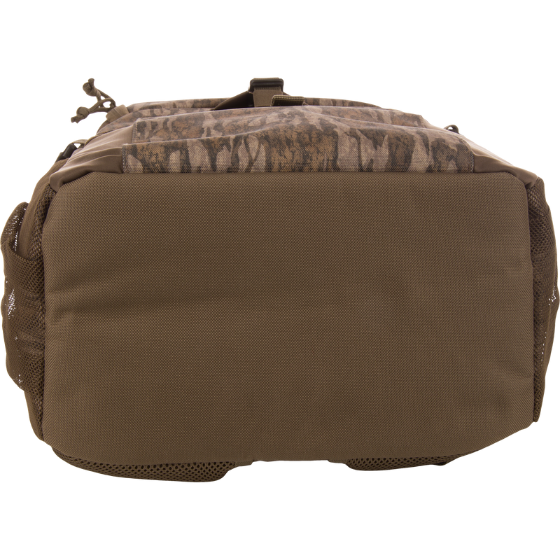 Underside of the Drake Day Pack, showcasing heavy-duty fabric with mesh side pockets, designed for rugged adventures with comfort shoulder straps and versatile storage options.