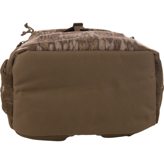 Underside of the Drake Day Pack, showcasing heavy-duty fabric with mesh side pockets, designed for rugged adventures with comfort shoulder straps and versatile storage options.