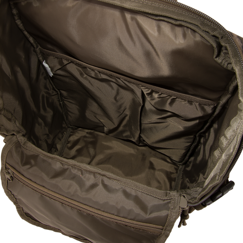 Drake Day Pack interior with main compartment, slip pockets, and buckle hardware, showcasing rugged, water-resistant design for versatile, comfortable carrying.